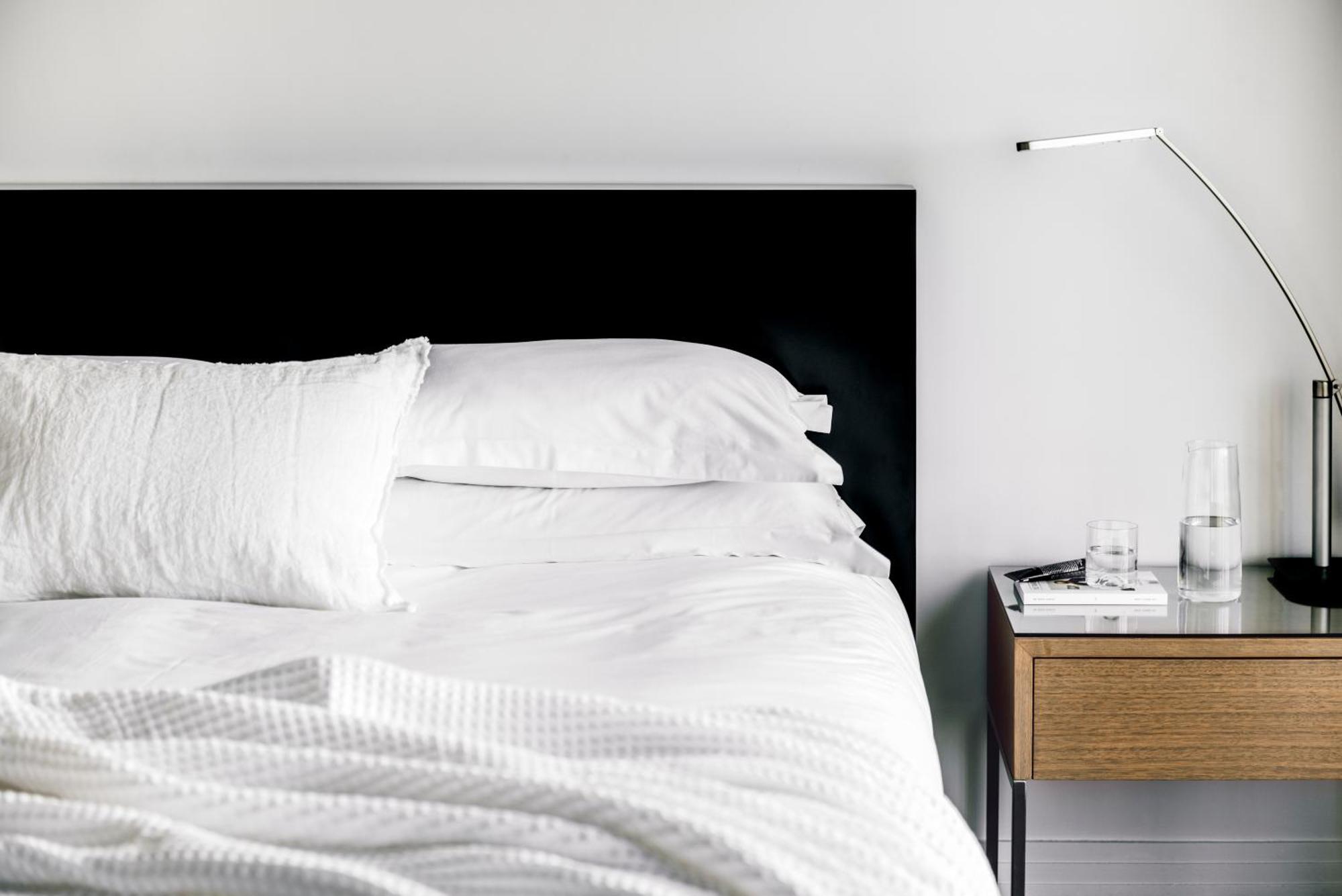 The Como Melbourne Kültér fotó A bed with a black headboard